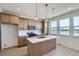 Contemporary kitchen with island sink, wood cabinets, stainless appliances and a view at 20588 E 63Rd Ave, Aurora, CO 80019