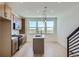 Modern kitchen with island, pendant lights, and stainless steel appliances at 20588 E 63Rd Ave, Aurora, CO 80019