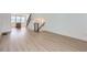 Open concept living space features hardwood floors and stairs with black railings at 20588 E 63Rd Ave, Aurora, CO 80019