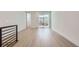 Bright second floor living room with access to the balcony and modern black railings at 20588 E 63Rd Ave, Aurora, CO 80019