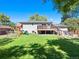 Expansive backyard with lush lawn, wooden deck, and playset at 6684 S Buffalo Dr, Littleton, CO 80120