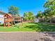 Lush backyard featuring a playset, expansive green grass, and a storage shed, ideal for Gathering enjoyment at 6684 S Buffalo Dr, Littleton, CO 80120