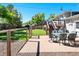 Inviting backyard patio with outdoor seating, grassy area, play set, and access to a spacious wooden deck at 6684 S Buffalo Dr, Littleton, CO 80120