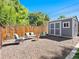 Secluded backyard area with a storage shed, comfortable seating, and a charming fire pit for relaxation at 6684 S Buffalo Dr, Littleton, CO 80120