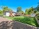 Spacious backyard with green grass, playset, storage shed, deck, and areas perfect for outdoor activities at 6684 S Buffalo Dr, Littleton, CO 80120