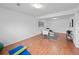 Finished basement area with seating and decor on top of wood-look flooring at 6684 S Buffalo Dr, Littleton, CO 80120