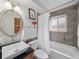 Bathroom featuring an oval mirror, decor, and a shower-tub combo behind a white curtain at 6684 S Buffalo Dr, Littleton, CO 80120
