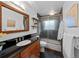 Bathroom featuring a granite vanity, dark tile floor, and glass shower at 6684 S Buffalo Dr, Littleton, CO 80120