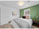 Bright bedroom featuring an accent wall, plush bedding, and natural light from a window at 6684 S Buffalo Dr, Littleton, CO 80120