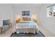 Inviting bedroom with a queen-size bed, blue accents, and natural light at 6684 S Buffalo Dr, Littleton, CO 80120