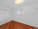 Walk-in closet with ample shelving and storage space, featuring hardwood flooring at 6684 S Buffalo Dr, Littleton, CO 80120