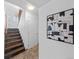 Entryway with stairs, tiled floor, and decorative art, creating a welcoming space at 6684 S Buffalo Dr, Littleton, CO 80120
