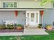 Inviting front entrance with a white door, decorative wreath, and charming plants at 6684 S Buffalo Dr, Littleton, CO 80120