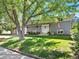 Charming two-story home with American flag, gray brick facade, and inviting white front door at 6684 S Buffalo Dr, Littleton, CO 80120