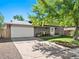 Charming two-story home featuring a manicured lawn, gray brick facade, and inviting white front door at 6684 S Buffalo Dr, Littleton, CO 80120