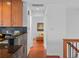Hallway view with hardwood floors, leading to other rooms in the house at 6684 S Buffalo Dr, Littleton, CO 80120