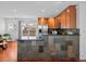 Modern kitchen featuring stainless steel appliances, granite counters, and wooden cabinets at 6684 S Buffalo Dr, Littleton, CO 80120