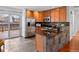Modern kitchen featuring stainless steel appliances, stone counters, and wooden cabinets at 6684 S Buffalo Dr, Littleton, CO 80120