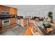 Bright, modern kitchen with stainless steel appliances, wood cabinets, and black countertops at 6684 S Buffalo Dr, Littleton, CO 80120