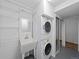 Convenient laundry room featuring a stacked washer and dryer unit and shelving at 6684 S Buffalo Dr, Littleton, CO 80120