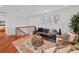 Cozy living room showcasing hardwood floors, a stylish rug, and bright natural light at 6684 S Buffalo Dr, Littleton, CO 80120
