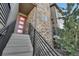 A beautifully designed entrance with stone accents and a modern red door, complemented by sleek black railings at 2602 Meadows Blvd # A, Castle Rock, CO 80109