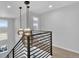 Modern stairway featuring contemporary lighting fixtures and a sleek black metal railing at 2602 Meadows Blvd # A, Castle Rock, CO 80109