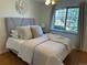 Cozy bedroom with a plush bed, decorative pillows, and natural lighting at 751 Eudora St, Denver, CO 80220