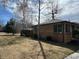 Charming brick home with mature trees and well-maintained lawn at 751 Eudora St, Denver, CO 80220