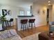 Open kitchen with counter seating, hardwood floors, and bright light at 751 Eudora St, Denver, CO 80220