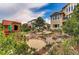 Picturesque backyard featuring a play structure, fire pit, and serene landscaping, ideal for Gathering fun and relaxation at 1970 Woodbourne Ter, Castle Rock, CO 80104