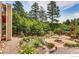 Beautiful backyard with lush landscaping, a fire pit, and a fun play area for , perfect for outdoor enjoyment at 1970 Woodbourne Ter, Castle Rock, CO 80104