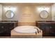 Elegant bathroom boasts a large soaking tub with dual sinks and granite countertop at 1970 Woodbourne Ter, Castle Rock, CO 80104