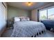 Comfortable bedroom with a decorative bed, side table and window with neighborhood views at 1970 Woodbourne Ter, Castle Rock, CO 80104