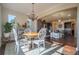 Sunlit dining room featuring a round table with views into the gourmet kitchen at 1970 Woodbourne Ter, Castle Rock, CO 80104