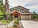 Charming two-story home with a stone-accented front and a well-manicured front yard at 1970 Woodbourne Ter, Castle Rock, CO 80104