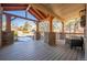 Spacious covered porch with wooden beams, stone pillars and comfortable outdoor seating at 1970 Woodbourne Ter, Castle Rock, CO 80104