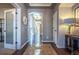 Hallway with hardwood floors, decorative lighting, and arched doorway, creating a bright and welcoming atmosphere at 1970 Woodbourne Ter, Castle Rock, CO 80104