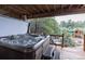 Relaxing hot tub on a private deck with scenic views of the surrounding trees and greenery at 1970 Woodbourne Ter, Castle Rock, CO 80104