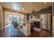 Beautiful kitchen with dark cabinets, stainless steel appliances, granite countertops, and an eat-in island at 1970 Woodbourne Ter, Castle Rock, CO 80104