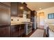 Kitchen featuring dark cabinets, stainless steel appliances, and tile backsplash at 1970 Woodbourne Ter, Castle Rock, CO 80104