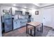 Modern kitchen featuring stainless steel appliances, gray cabinets, granite counters, and a cozy dining area at 1970 Woodbourne Ter, Castle Rock, CO 80104