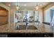 Stylish kitchen sink and granite countertops overlooking the living room at 1970 Woodbourne Ter, Castle Rock, CO 80104