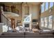 Open living room with high ceilings, fireplace, hardwood floors and staircase at 1970 Woodbourne Ter, Castle Rock, CO 80104