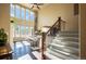 Bright living room featuring large windows, hardwood floors, and a staircase with iron balusters at 1970 Woodbourne Ter, Castle Rock, CO 80104