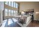 Spacious living room with a wall of windows, hardwood floors, and comfortable seating at 1970 Woodbourne Ter, Castle Rock, CO 80104