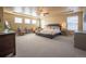 A large main bedroom with a ceiling fan and a gray accent wall at 1970 Woodbourne Ter, Castle Rock, CO 80104