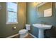 Compact powder room with a pedestal sink, window, and neutral-toned walls at 1970 Woodbourne Ter, Castle Rock, CO 80104