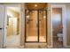 Bathroom featuring an elegant glass enclosed shower with tile surround and dark fixtures at 1970 Woodbourne Ter, Castle Rock, CO 80104