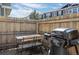 Outdoor patio area with a grill and wooden picnic table, perfect for entertaining or relaxing at 17148 Waterhouse Cir # A, Parker, CO 80134